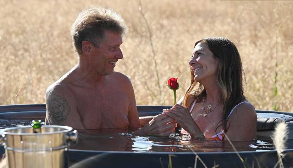 Gerry Turner gives a rose to Leslie while they're both in an outdoor hot tub on "The Golden Bachelor."