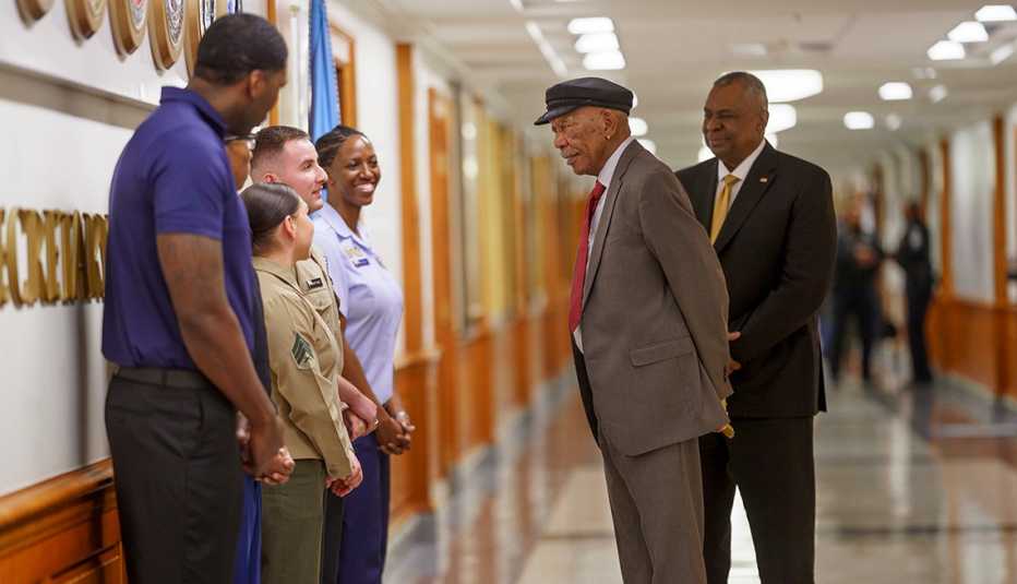 morgan freeman having conversation with pentagon military personnel with secretary of defense lloyd j austin the third alongside him in a scene from the history channel documentary 761st tank battalion the original black panthers