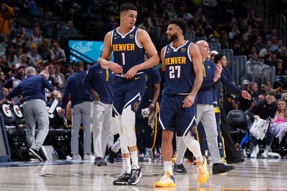 Michael Porter Jr. and Jamal Murray look at each other while walking on the court during a game against the Indiana Pacers in Denver