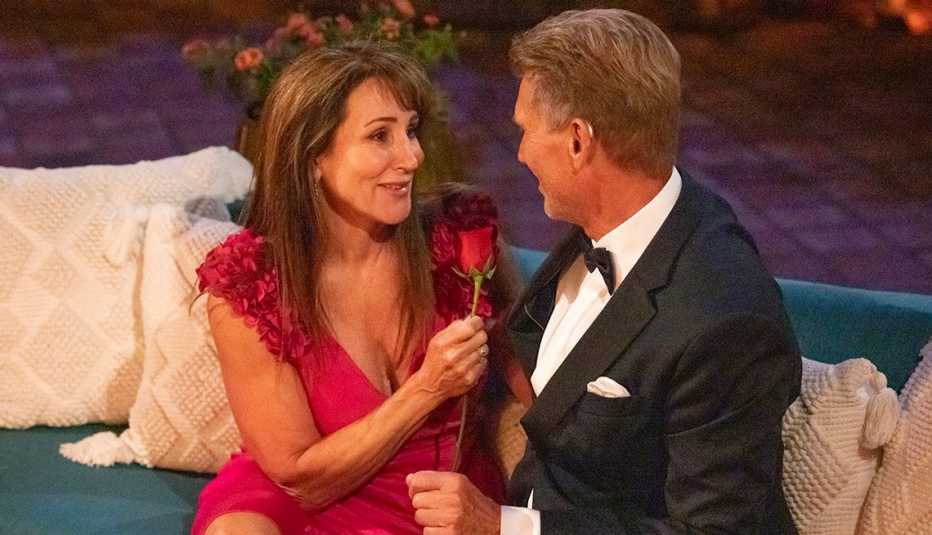 Faith holding a rose while sitting next to Gerry Turner on "The Golden Bachelor."