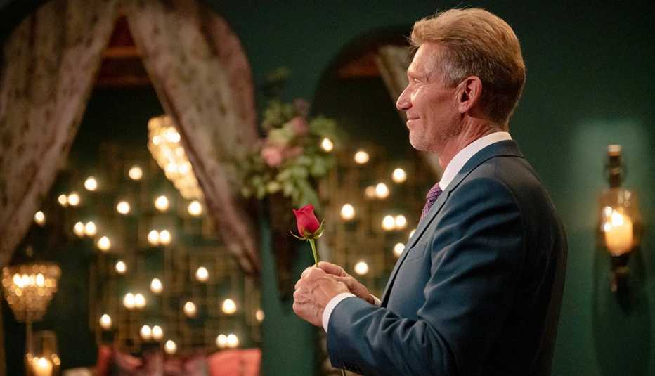 the golden bachelor gerry turner holds a rose on the abc reality dating show