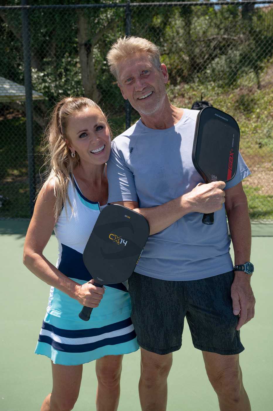 the bachelorette star trista sutter and the golden bachelor gerry turner holding pickleball rackets