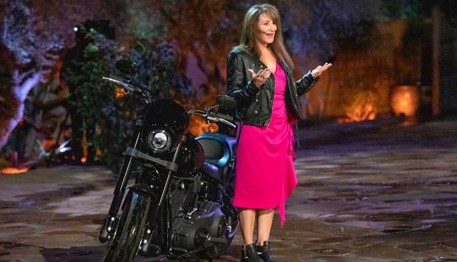 Faith standing in front of a motorcycle on "The Golden Bachelor."