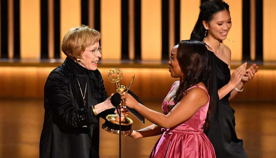 Quinta Brunson accepts her Emmy award from Carol Burnett onstage at the 75th Emmy Awards