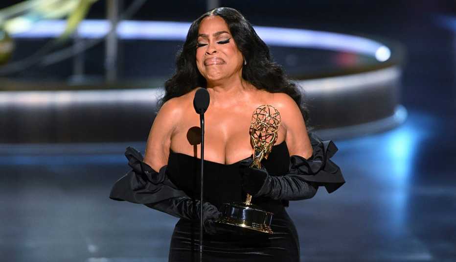 Niecy Nash-Betts holds her trophy onstage at the 75th Emmy Awards