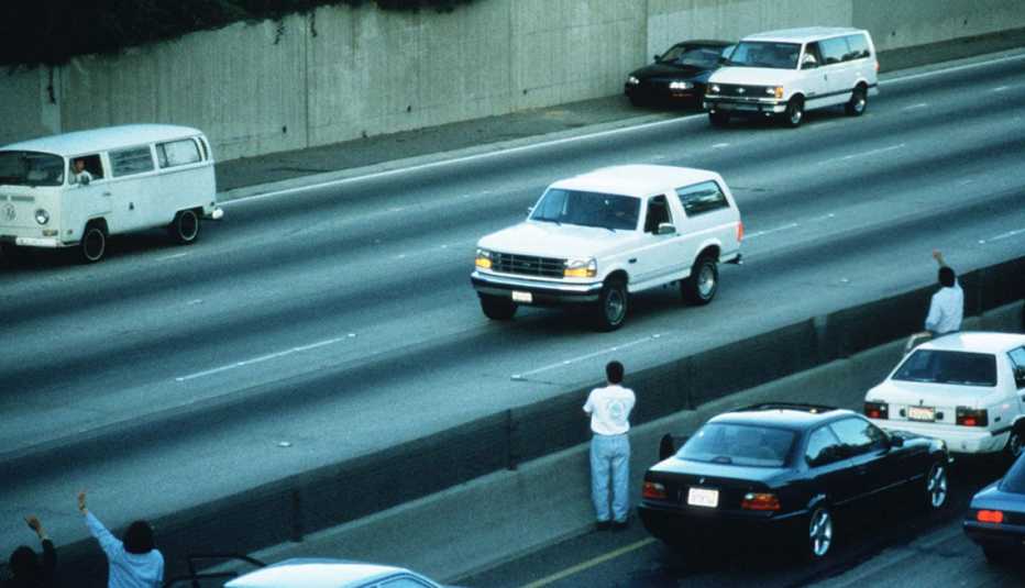 motorists waving as police cars pursue the ford bronco driven by al cowlings carrying o j simpson on a ninety minute slow speed car chase