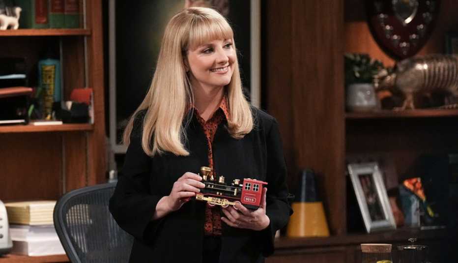 Melissa Rauch holding a toy train in "Night Court."