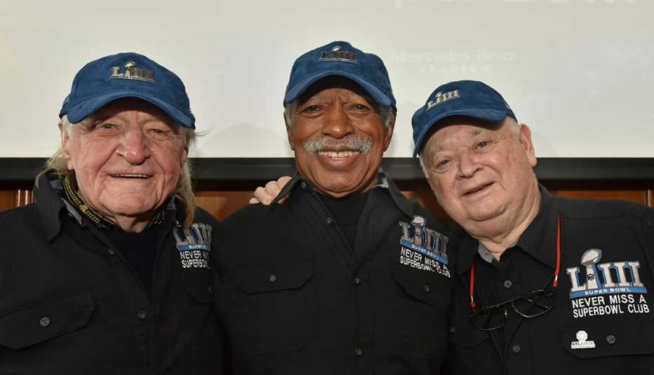 Members of the Never Miss a Super Bowl Club, from left, Tom Henschel, Gregory Eaton and Don Crisman, pose for a group photograph during a 2019 welcome luncheon in Atlanta. 