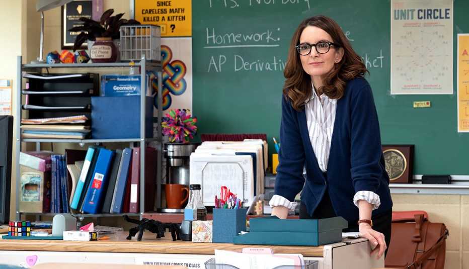 Tina Fey standing behind a desk in a classroom in the 2024 film "Mean Girls"