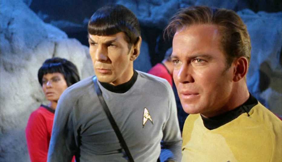 from left to right nichelle nichols as lieutenant nyoa uhura then leonard nimoy as mr spock then william shatner as captaion james kirk in star trek the original series 