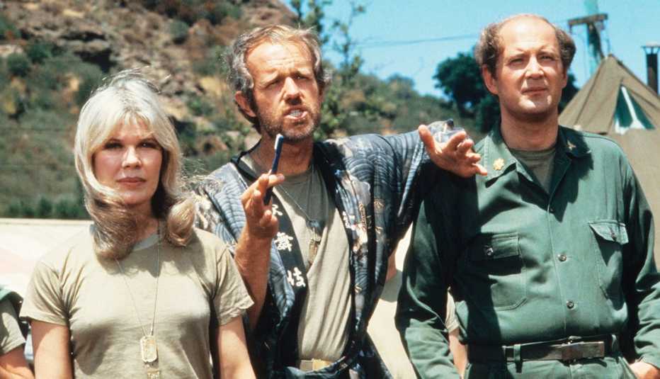 from left to right loretta swit then mike farrell then david ogden stiers on the t v show mash