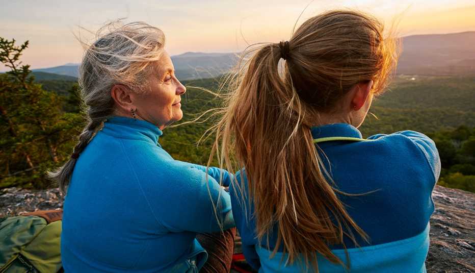 two women stare off at hills