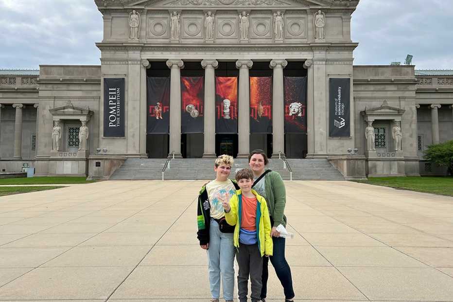 a family stands in front of the museum of science and industry in chicago