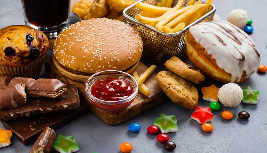 assortment of unhealthy processed foods on a gray background