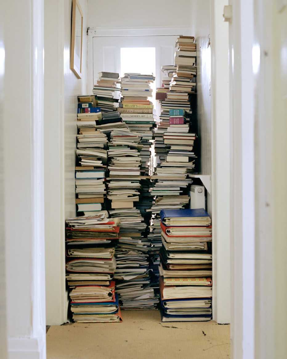 stacks of books in a hallway