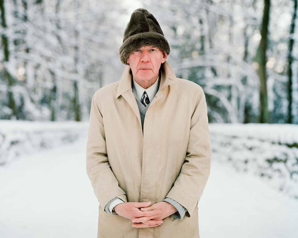man standing outside in snowy landscape with hat and coat