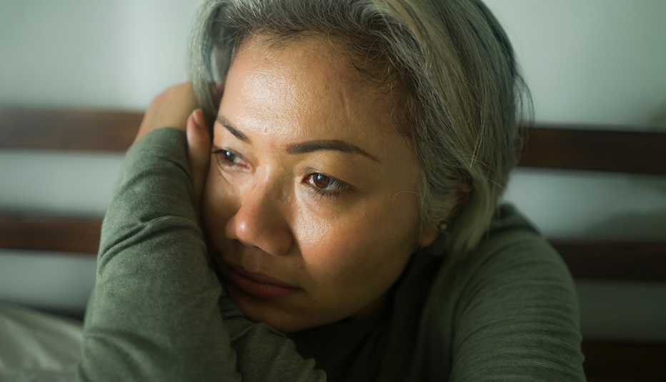 Woman looking depressed, leaning her head on her arm