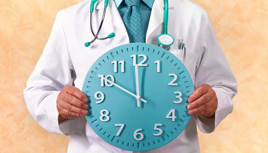 Doctor holding a clock 