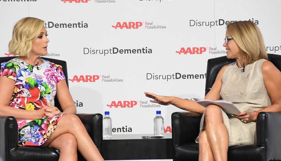 Actress Jane Krakowski sitting across from interviewer Katie Couric. Backdrop says: AARP: Disrupt Dementia.