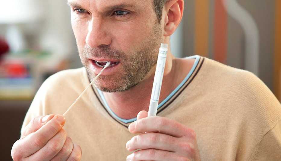 Man swabbing his mouth for dna test