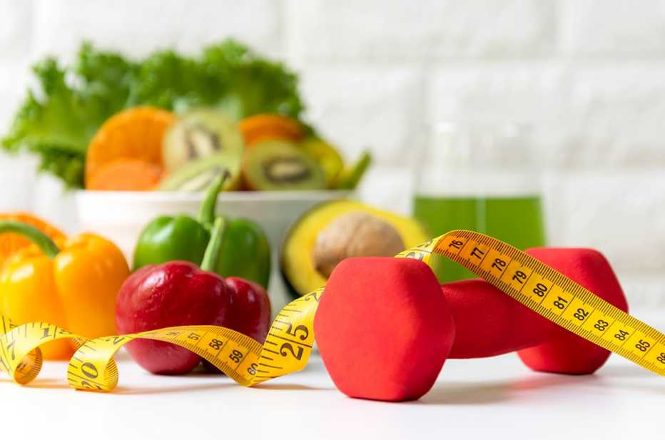 healthy vegetables, fruits, smoothie, plus a hand weight and tape measure
