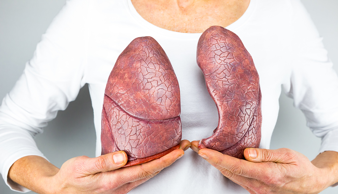 Woman holding models of lungs
