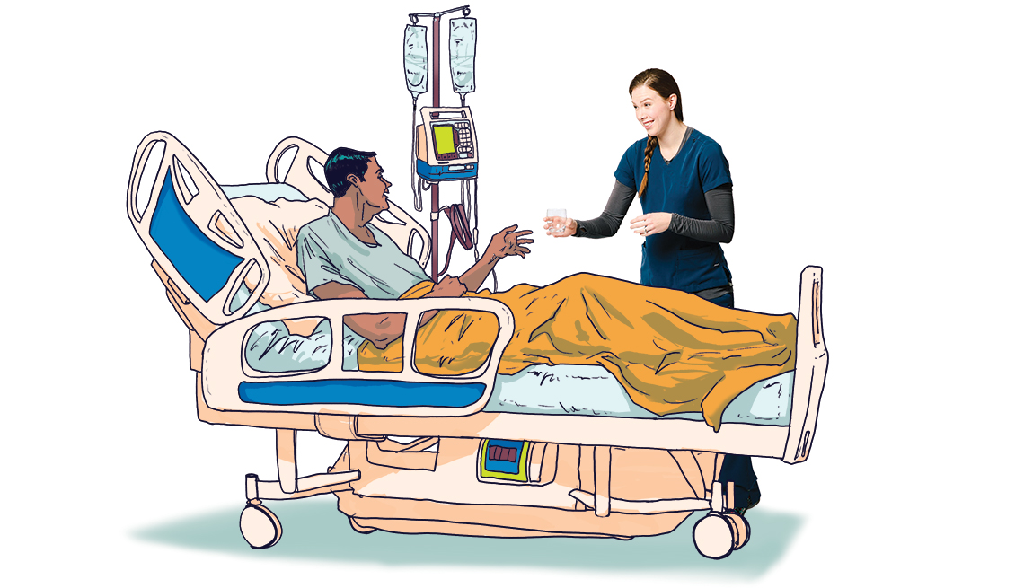 Nurse helps a patient in his hospital bed 