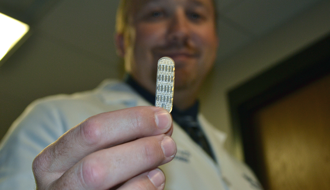 Doctor holding an electrode for a spinal-cord stimulator