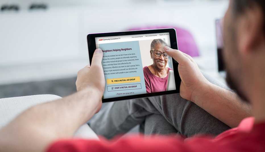 man looking at community connections website on a tablet at home