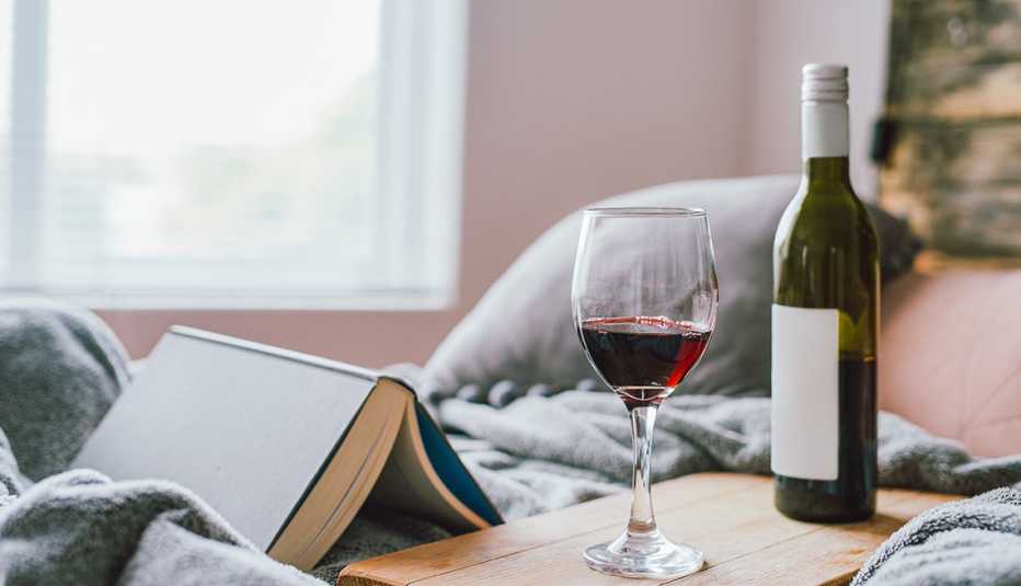 Reading a book and drinking wine