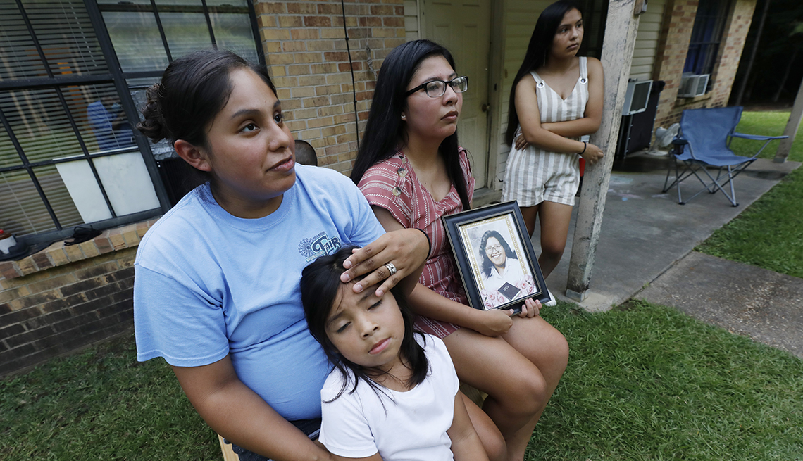 Sisters Kristi Wishork, left, consoles her daughter Renaya Farmer, 5, as she and her sisters Kristina Taylor, center and Kaydee Taylor, right recall the family pride and love their late mother, Sharon Taylor, had for their family, Tuesday, July 21, 2020 o