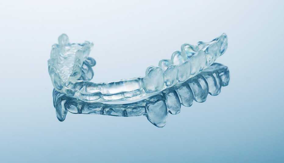 Close up of a dental bite guard on a blue background