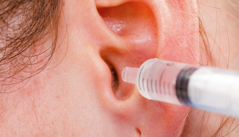 medical ear wash with water in syringe