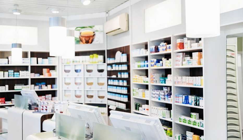 A pharmacy counter before the store has opened, with medicine on display behind the checkouts.