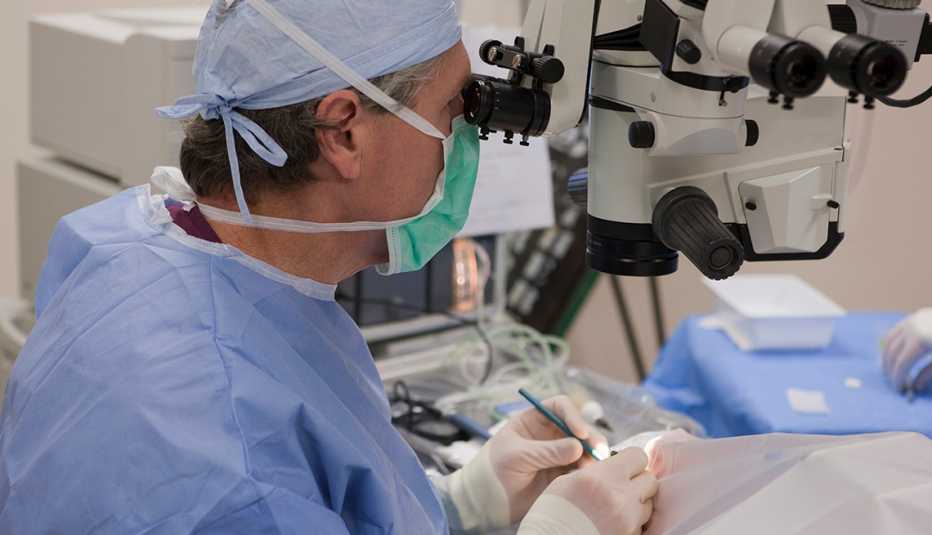 doctor in scrubs performing eye surgery