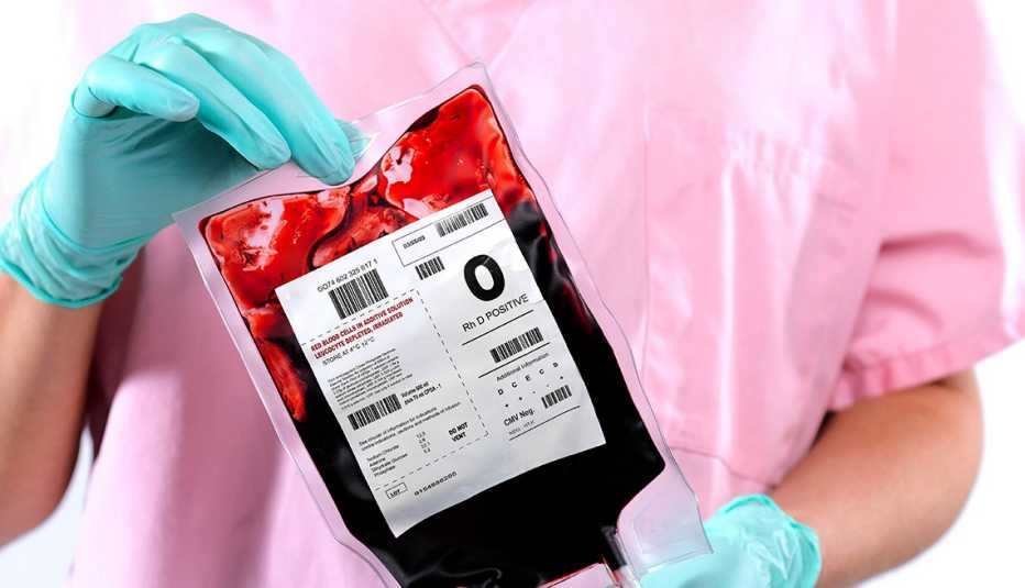 Nurse holding a bag of O positive blood.
