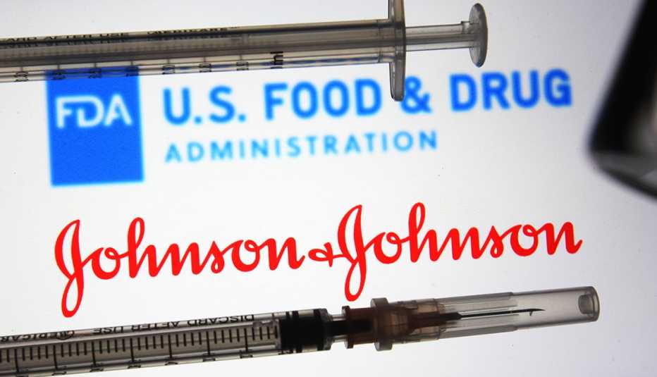 Vaccine syringes in front of logos of the U.S. FDA and Johnson and Johnson.