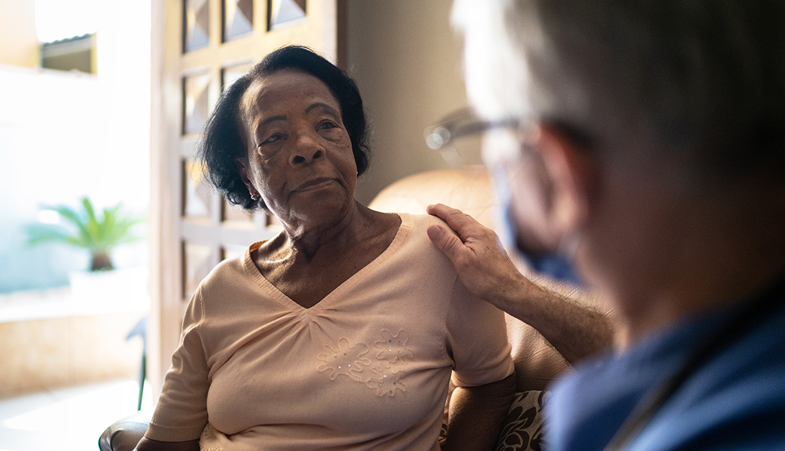 woman at home being seen by a visiting caregiver