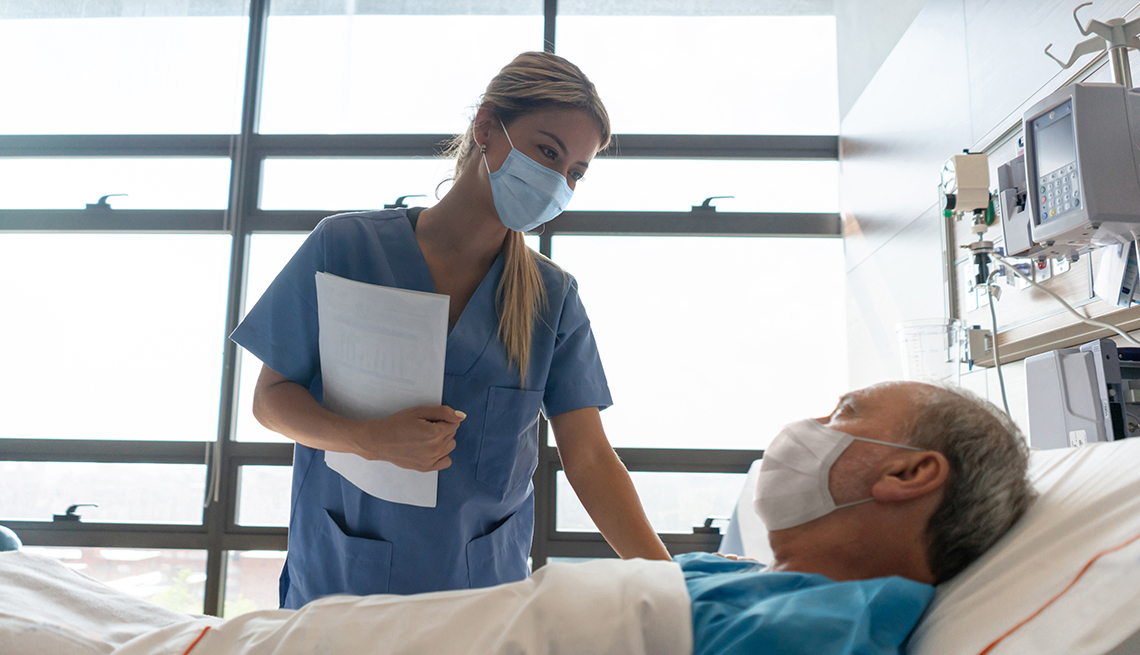 Nurse and patient wearing mask in hospital