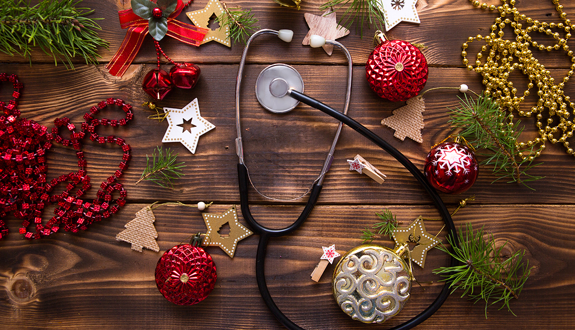 Stethoscope on a wood background surrounded by Christmas decorations
