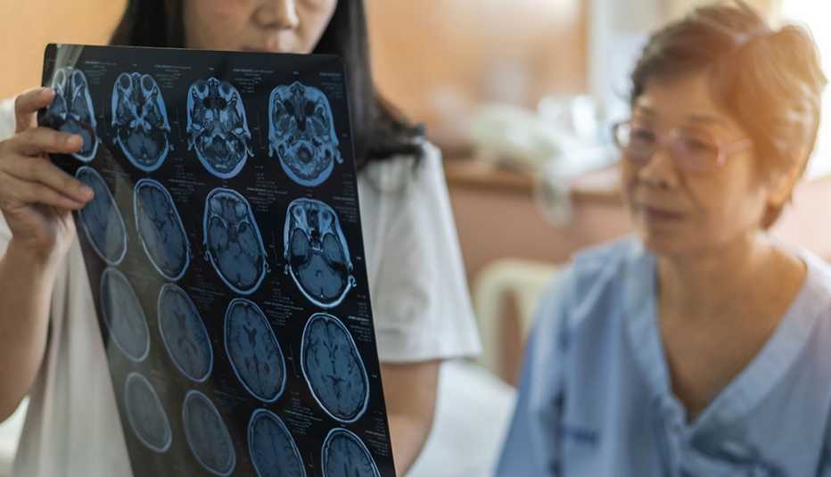 Brain disease diagnosis with medical doctor diagnosing older patient
