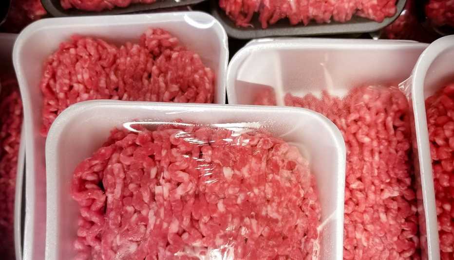 a variety of packages of ground beef at the supermarket