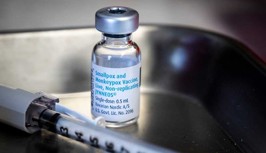 vial of monkeypox vaccine and syringe lying on a tray