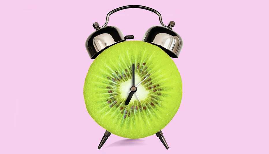 an alarm clock made out of a sliced kiwi to symbolize foods for sleep