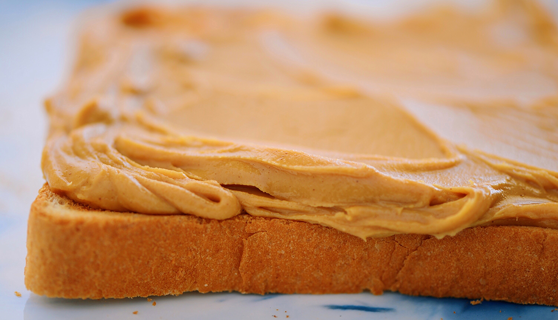 close up of peanut butter on bread