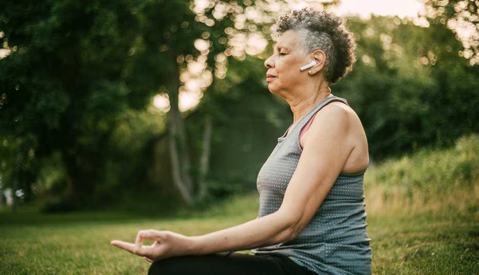 woman meditating with headphones in