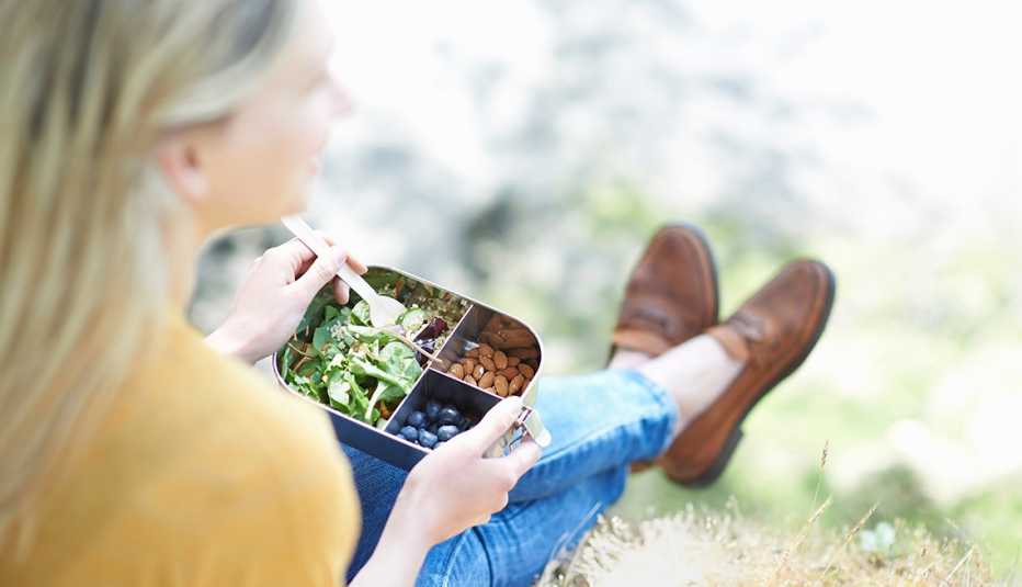 woman eating healthy lunch outdoors
