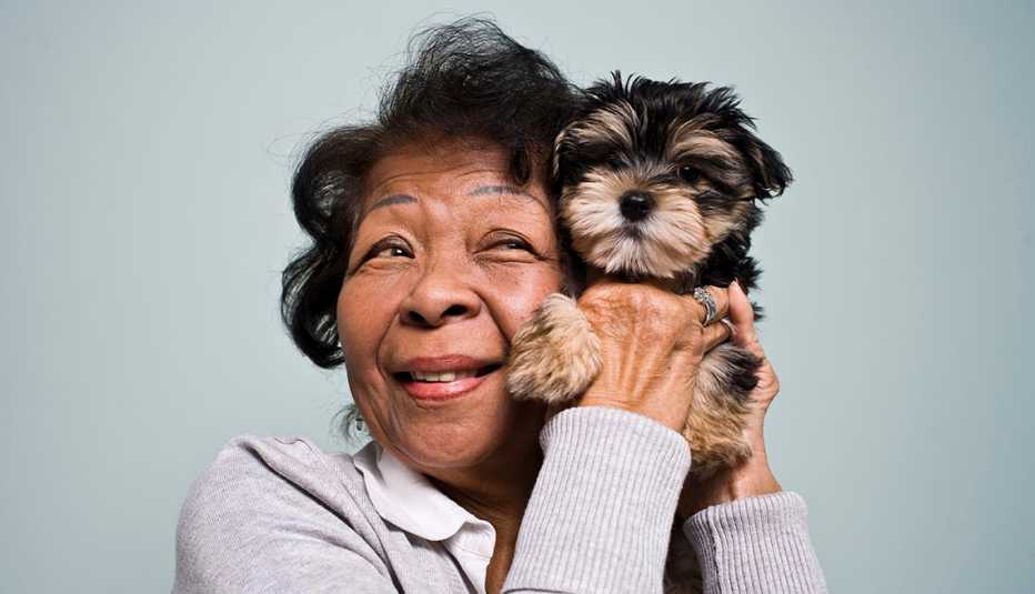 woman holding a puppy