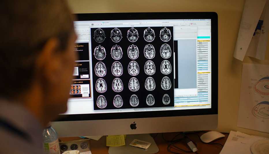 researcher looks at brain scans