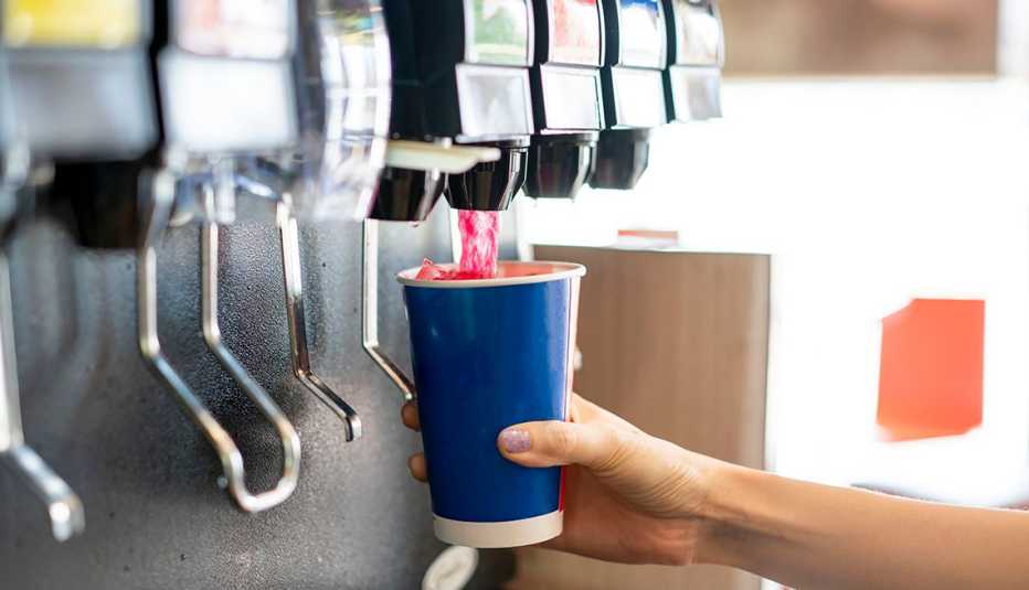 filling a cup at the soda fountain